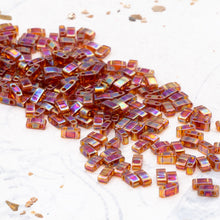 Load image into Gallery viewer, Transparent Dark Topaz AB Half Tila Beads
