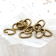 Load image into Gallery viewer, Antique Gold 9mm Textured Oval Jump Rings - 12pcs
