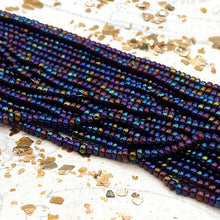Load image into Gallery viewer, 10/0 Metallic Dark Iris Rainbow Seed Bead Hank
