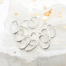 Load image into Gallery viewer, Pre-Order Sterling Silver Plated 9mm Textured Oval Jump Rings - 12pcs
