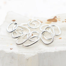 Load image into Gallery viewer, Pre-Order Sterling Silver Plated 9mm Textured Oval Jump Rings - 12pcs
