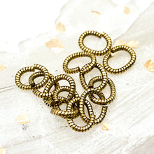 Load image into Gallery viewer, 6mm Textured Antique Gold Oval Jump Ring Set - 12pcs
