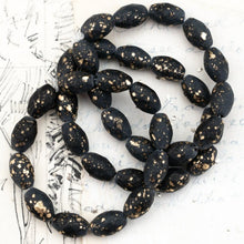 Load image into Gallery viewer, 12x8mm Black with a Matte and Gold Finish  Faceted Oval Bead Strand
