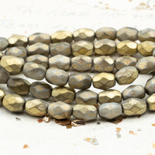 Load image into Gallery viewer, 6mm Faceted Oval Pale Grey with Etched and Gold Finishes, approximately 6x9mm
